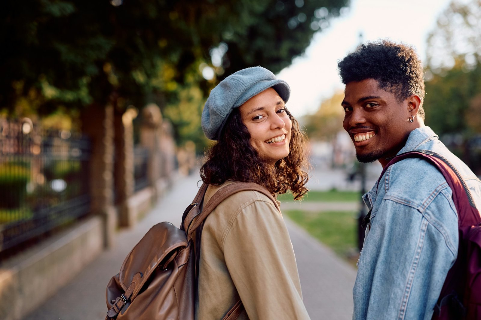 Happy multiracial couple in the city looking at camera.